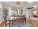 Bright dining room with a large table, hardwood floors, and a window providing natural light at 508 Via Palermo Dr, Henderson, NV 89011