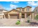 Beautiful two-story home featuring a three-car garage, rock landscaping, and a welcoming stone-accented entrance at 508 Via Palermo Dr, Henderson, NV 89011