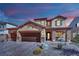 Charming two-story home featuring a desert landscape, multi-car garage, and stone facade accents at 508 Via Palermo Dr, Henderson, NV 89011