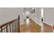 Upstairs hallway with wood floors, neutral paint, wood railing, and artwork on the walls at 508 Via Palermo Dr, Henderson, NV 89011