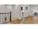 Hallway view featuring hardwood floors, a staircase, and a laundry area, bathed in natural light at 508 Via Palermo Dr, Henderson, NV 89011
