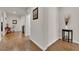 Hallway with archways, wood floors, and view into a room with a chair and side table at 508 Via Palermo Dr, Henderson, NV 89011