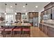 Spacious kitchen with dark wood cabinets, stainless steel appliances, a large island, and modern lighting at 508 Via Palermo Dr, Henderson, NV 89011
