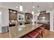 Well-equipped kitchen with a large granite island, dark wood cabinets, and modern stainless steel appliances at 508 Via Palermo Dr, Henderson, NV 89011