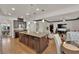 Open-concept kitchen featuring dark wood cabinets, a granite island, and seamless flow into the living area at 508 Via Palermo Dr, Henderson, NV 89011