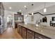 Kitchen featuring a large granite island, stainless appliances, pendant lighting, and seamless access to the living room at 508 Via Palermo Dr, Henderson, NV 89011