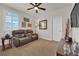 Cozy living room features a comfortable leather sofa, bright windows, and a ceiling fan at 508 Via Palermo Dr, Henderson, NV 89011