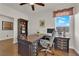 Bright home office with a spacious desk, wood floors, and a view from the window at 508 Via Palermo Dr, Henderson, NV 89011