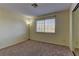 This neutral carpeted bedroom features a large window and a standard closet at 5345 Silvermist Ct # 203, Las Vegas, NV 89122
