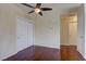 Bedroom featuring hardwood floors, a ceiling fan, and a closet with sliding doors at 5345 Silvermist Ct # 203, Las Vegas, NV 89122