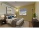 Staged bedroom featuring a queen bed, hardwood floors, natural light, and modern decor at 5345 Silvermist Ct # 203, Las Vegas, NV 89122