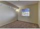 Bright bedroom with neutral walls and carpet has a sunny window providing natural light at 5345 Silvermist Ct # 203, Las Vegas, NV 89122
