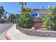 Well-maintained Duck Creek Village entrance featuring lush landscaping and a decorative stone sign at 5345 Silvermist Ct # 203, Las Vegas, NV 89122