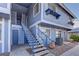 Charming condo exterior with blue siding, complemented by a staircase and manicured landscaping at 5345 Silvermist Ct # 203, Las Vegas, NV 89122