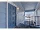 View of blue-painted front door with a brushed gold door number, at unit 203, on a covered landing at 5345 Silvermist Ct # 203, Las Vegas, NV 89122