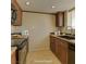 Traditional kitchen with dark wood cabinets, tile flooring, and neutral countertops at 5345 Silvermist Ct # 203, Las Vegas, NV 89122