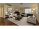 Bright, staged living room with fireplace, hardwood floors, neutral furniture, and natural light at 5345 Silvermist Ct # 203, Las Vegas, NV 89122