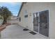 Backyard view of a home with a concrete patio and textured exterior wall at 5784 Dew Mist Ln, Las Vegas, NV 89110