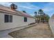 Backyard view of a home with landscaping space and a block fence at 5784 Dew Mist Ln, Las Vegas, NV 89110