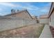 Backyard view of a home with a block fence at 5784 Dew Mist Ln, Las Vegas, NV 89110