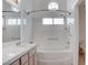 Bright bathroom showcasing a tiled bathtub with shower, a window, and a single sink vanity at 5784 Dew Mist Ln, Las Vegas, NV 89110