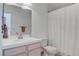 Bathroom featuring a single sink vanity and a shower with curtain at 5784 Dew Mist Ln, Las Vegas, NV 89110