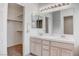 Well-lit bathroom with double sinks, a large mirror, and access to a walk-in closet at 5784 Dew Mist Ln, Las Vegas, NV 89110