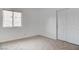 Bright bedroom with neutral carpet, a window, and a closet at 5784 Dew Mist Ln, Las Vegas, NV 89110
