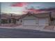 Front exterior of home featuring a two-car garage and desert landscaping at 5784 Dew Mist Ln, Las Vegas, NV 89110