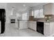 Charming kitchen featuring black appliances and a view into the living area at 5784 Dew Mist Ln, Las Vegas, NV 89110