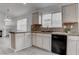 Well-lit kitchen with black appliances, tile backsplash, and ample counter space at 5784 Dew Mist Ln, Las Vegas, NV 89110