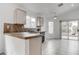 Bright kitchen with a breakfast bar, tile countertops, and sliding glass doors at 5784 Dew Mist Ln, Las Vegas, NV 89110