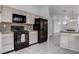 Spacious kitchen featuring black appliances and tile floors, perfect for Gathering meals at 5784 Dew Mist Ln, Las Vegas, NV 89110