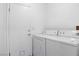 This laundry room features a washer and dryer along with a utility sink at 5784 Dew Mist Ln, Las Vegas, NV 89110