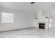 Open living area with tile floors, a modern fireplace, and natural light from a large window at 5784 Dew Mist Ln, Las Vegas, NV 89110
