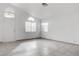 Bright living room featuring tile floors and a vaulted ceiling with lots of natural light at 5784 Dew Mist Ln, Las Vegas, NV 89110