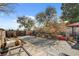 Private backyard featuring a concrete patio area, mature trees, and a pergola at 5785 N Tee Pee Ln, Las Vegas, NV 89149