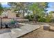 Spacious backyard with mature trees, a concrete patio, and room for outdoor activities at 5785 N Tee Pee Ln, Las Vegas, NV 89149