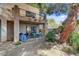 Outdoor patio area with dining set, spiral staircase access to balcony and xeriscaping at 5785 N Tee Pee Ln, Las Vegas, NV 89149