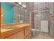 Bathroom with sink, toilet, shower, and blue accent wall at 5785 N Tee Pee Ln, Las Vegas, NV 89149