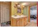 Charming bathroom featuring a classic vanity, decorative mirror, and tiled shower at 5785 N Tee Pee Ln, Las Vegas, NV 89149