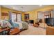 Bedroom with tile floors, yellow colored walls, closet, and sliding glass doors to balcony at 5785 N Tee Pee Ln, Las Vegas, NV 89149