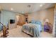 Bedroom with tile floors, light blue and beige walls, closet and access to bathroom at 5785 N Tee Pee Ln, Las Vegas, NV 89149