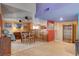 Another view of the dining area boasts a cozy setting for meals, complemented by natural light and a view into the kitchen at 5785 N Tee Pee Ln, Las Vegas, NV 89149