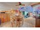 Open concept dining area flowing into the kitchen and living spaces, perfect for modern living and social gatherings at 5785 N Tee Pee Ln, Las Vegas, NV 89149