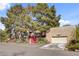 A private home exterior shows mature landscaping, large trees and a two-car garage at 5785 N Tee Pee Ln, Las Vegas, NV 89149