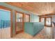 Hallway featuring wood-beamed ceilings, tiled floors and open access to other rooms at 5785 N Tee Pee Ln, Las Vegas, NV 89149
