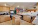 Open kitchen with an island, ample cabinetry, and modern appliances, making it a chef's delight for cooking and entertaining at 5785 N Tee Pee Ln, Las Vegas, NV 89149