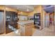 Well-equipped kitchen boasts stainless steel appliances, an island, and plenty of cabinet space for efficient meal preparation at 5785 N Tee Pee Ln, Las Vegas, NV 89149