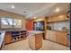 Functional kitchen features granite countertops, an island, and ample storage, creating a practical and stylish culinary space at 5785 N Tee Pee Ln, Las Vegas, NV 89149